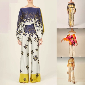 Detailed close-up showing silky fabric texture and various print patterns of two-piece sets