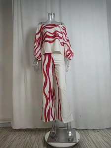 Detail of off-shoulder puff sleeve top and wide leg trousers with wavy abstract print