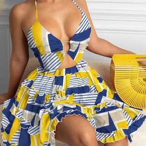 Detail of floral printed halter dress with waist cut-outs and layered ruffle hem design