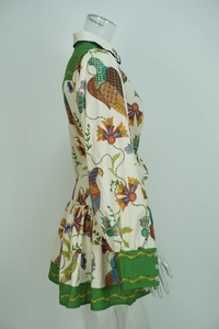 Detailed view of the lapel and colorful floral bird print on long-sleeved dress