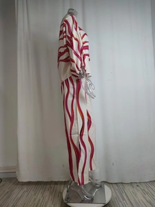 Side view of two-piece set featuring wave pattern wide-leg pants and loose long sleeve top