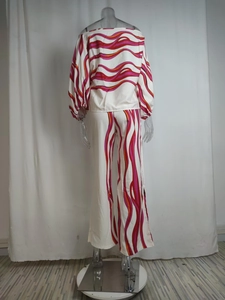 Rear view of off-shoulder lantern sleeve top and wide-leg trousers with wave print