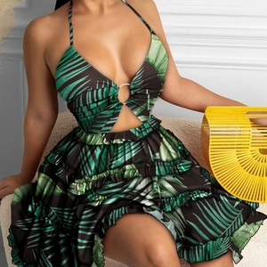 Detail of tropical palm print dress with neck ring detail and layered ruffle skirt