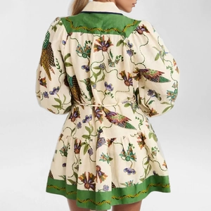 Detailed back view of a bohemian floral dress featuring balloon sleeves and waist tie design