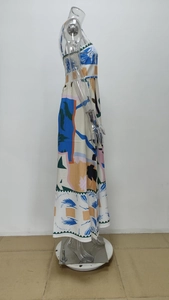 Detail view of colorful abstract graffiti print on a long bohemian vacation dress