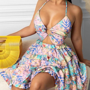 Close-up of tropical floral print dress with halter neck, metal ring and cutout detail