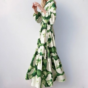 Detail view of long sleeve maxi dress with green tie-dye print and layered ruffle hem