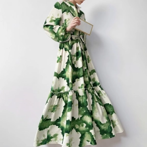 Detail view of V-neck collar and tiered skirt layers on floral print dress