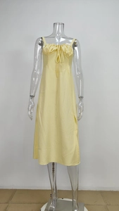 Close-up of the gathered neckline with a delicate drawstring bow on the floral dress