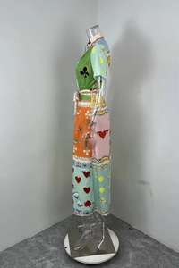 Detail view of graffiti print vintage dress featuring poker patterns and waist belt tie