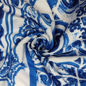 Detailed macro view of high-quality silk fabric with blue and white floral Mediterranean patterns