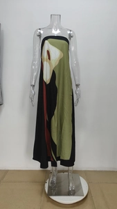Close-up of sleeveless strapless maxi dress with modern abstract print in green and black