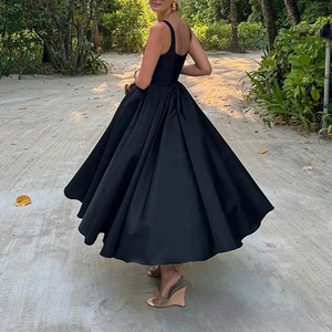 Elegant black sleeveless midi dress with wide flared skirt and satin sheen for women