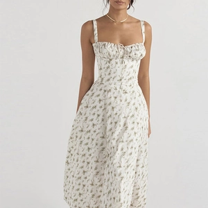 Detail of the tie-front bodice and floral print texture on a summer camisole dress
