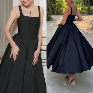 Detailed view of elegant black midi dress featuring square neck and slim waist structure