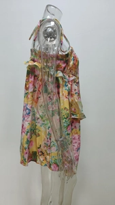 Detailed side view of floral print sundress with ruffled edge on light fabric
