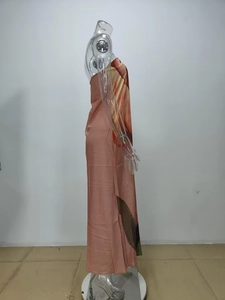 Side view of coral pink floral print off-shoulder maxi dress on a mannequin