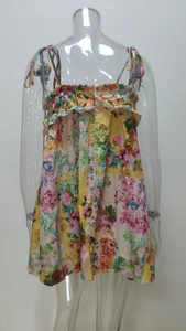 Detail of yellow floral dress with ruffle neck and adjustable spaghetti straps