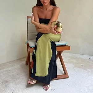 Sleeveless strapless maxi dress in black and olive green with metallic gold clutch bag