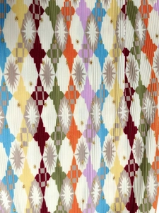 Detailed macro view of pleated fabric with colorful geometric diamond patterns and star motifs
