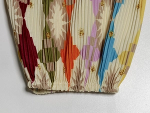 Macro view of pleated fabric with geometric star patterns and elastic cuff detail
