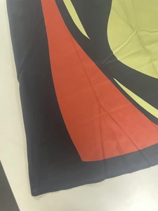 Detail of printed sleeveless maxi dress showing geometric patchwork and stitching