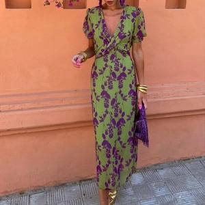 Detail of V-neckline and twist knot design on a green floral print summer dress