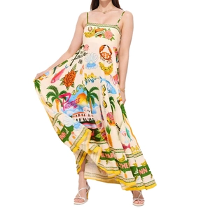 Detail of tropical print and yellow hem on a cream sleeveless vacation maxi dress