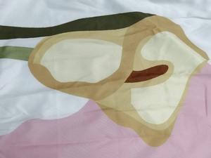 Close-up of abstract floral print fabric on sleeveless dress with soft pastel tones