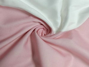 Detailed macro view showing soft pink and white polyester blend fabric with smooth plain weave