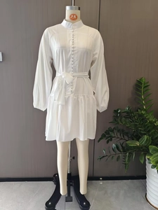 Detailed view of white lantern sleeves and stand collar with decorative buttons