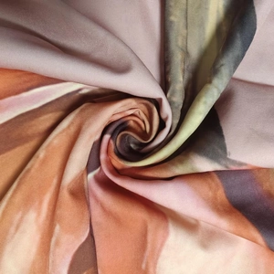 Macro shot of colorful abstract print fabric with smooth silky texture and soft drape detail