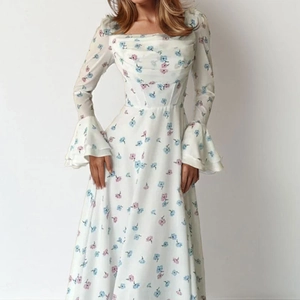 Detail of floral print maxi dress featuring elegant flared sleeves and square neckline