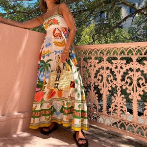 Chic cream-colored maxi sun dress with tropical prints and spaghetti straps for summer vacations
