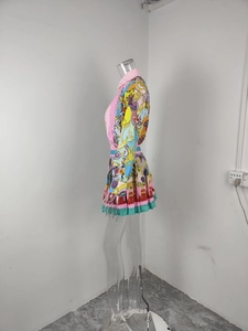 Detailed side view of baroque floral print long sleeve shirt and pleated skirt set for women