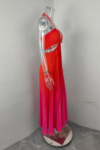 Detail view of the halter neck and waist cutout on orange-pink gradient pleated dress