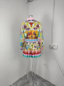 Detailed back view of a women's two-piece set with baroque print shirt and pleated skirt