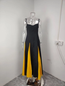 Detail of elegant black and yellow patchwork backless maxi dress with a geometric hemline