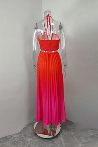 Detail of gradient pleated maxi skirt set with orange and pink ombre color transition