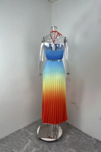 Back view of elegant blue halter top and pleated maxi dress with blue-orange gradient