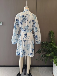 Rear view of floral long-sleeve dress with blue prints, puff sleeves and a waist belt
