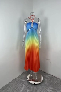 Detail of gradient pleated halter dress with vibrant blue to orange rainbow transition