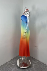 Detailed view of ombre pleated maxi dress with halter neck and vibrant gradient textures