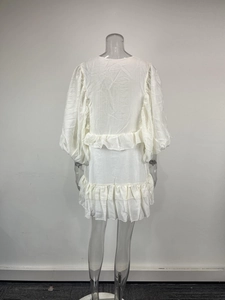 Rear view of white mini dress featuring elegant puff sleeves and tiered ruffle details