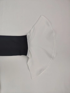 Detail view showing black long sleeve with contrasting white bell sleeve cuff design