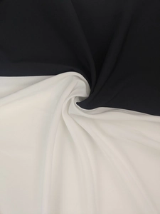Detailed macro view of black and white lightweight fabric with elegant drape and texture