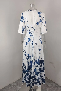 Detail view of the back zipper and blue floral pattern on white spring dress