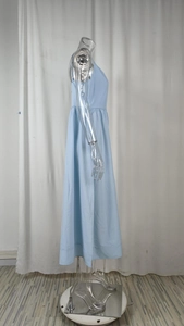 Détail de la taille haute plissée sur une robe longue bleu ciel à coupe évasée