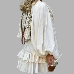 Elegant white bohemian mini dress with puff sleeves and ruffled hem side view