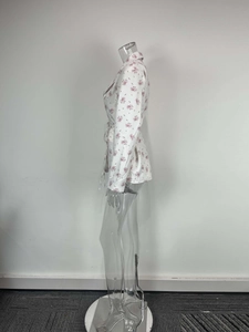 Detailed side view of floral print blazer featuring lapel collar and waist tie belt